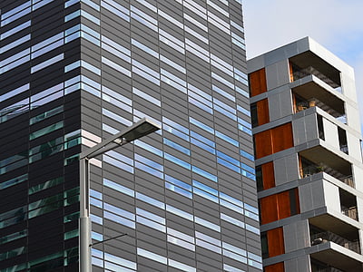 gray lamp post beside gray concrete high-rise building during daytime thumbnail