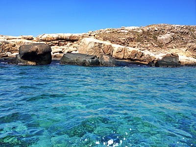clear blue sea beside rock formation thumbnail