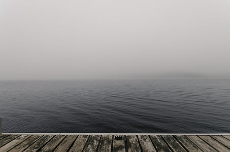 wooden dock under white clouds thumbnail