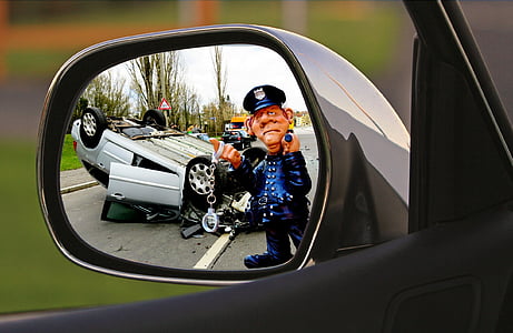 grey wrecked car on road near cop thumbnail