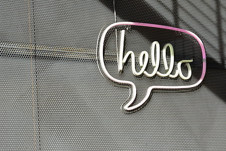 photo of pink and white Hello wall-mounted neon signage during daytime thumbnail