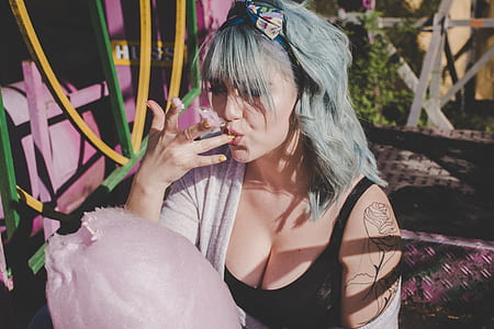 woman eating pink cotton candy thumbnail