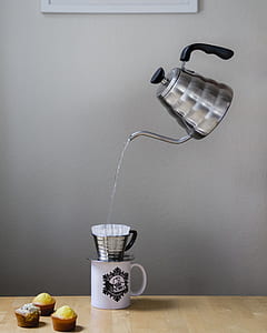 gray metal teapot floating white pouring stainless steel cup thumbnail