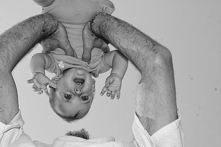 grayscale photo of man carrying baby thumbnail