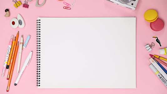 white notepad between color pens thumbnail