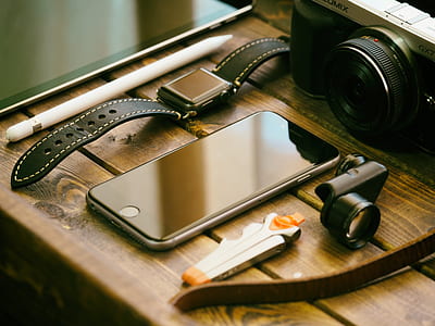 photo of space gray iphone beside clip lens and MILC camera thumbnail