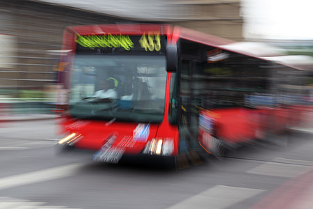 red and black bus on road near building thumbnail