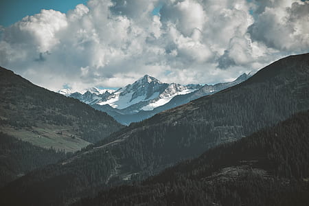 snow-covered mountain under cloudy sky thumbnail