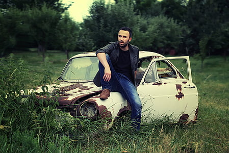 man sitting on white car thumbnail
