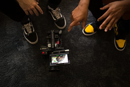two people looking at video camera thumbnail