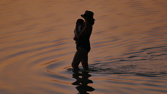 silhouette of a woman at body of water thumbnail