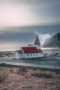 red and white cathedral near body of water thumbnail
