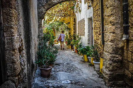 person walking between buildings at daytime thumbnail