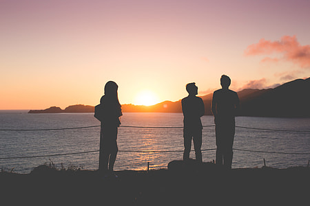 People Enjoying Sunset Over the Ocean thumbnail