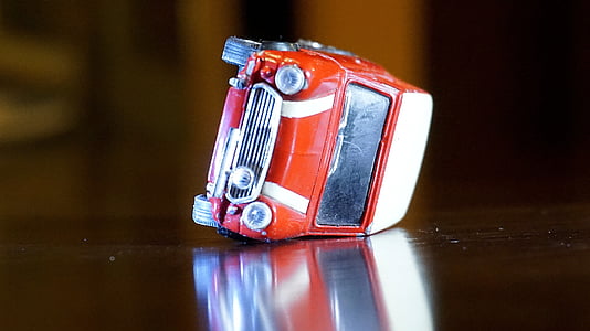 red Mini Cooper die-cast toy on table thumbnail
