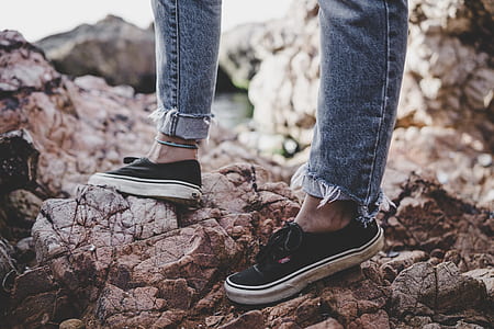 person standing on gray rocks thumbnail