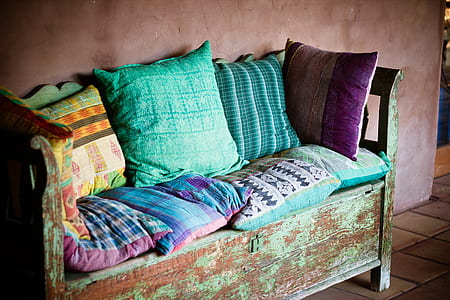 green and brown wooden couch with cushion and pillows thumbnail