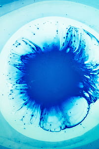 closeup photo of white paint with drop of blue paint thumbnail