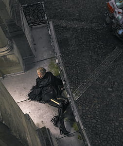 woman in black coat lying beside black handrail thumbnail
