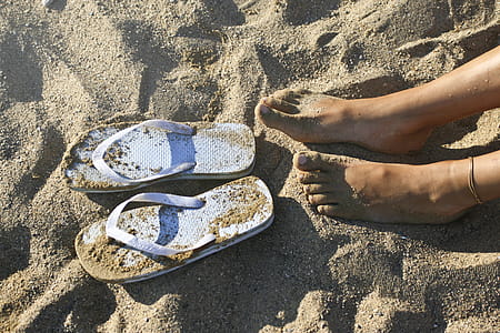 Photography of a Girl's Feet Near Flip-flops thumbnail