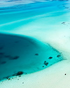 white sand near body of water thumbnail