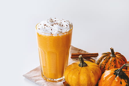 Pumpkin smoothie. Small pumpkins and drink on the white background thumbnail