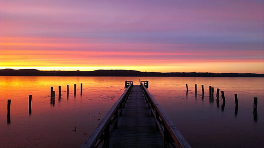 brown wooden dock during sunset thumbnail