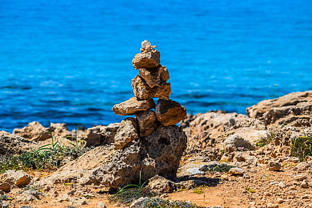 brown stones beside body of water thumbnail