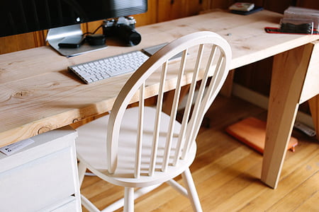 photo of brown wooden table and white wooden chair on brown parquet flooring thumbnail