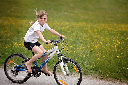 girl riding bike on road thumbnail