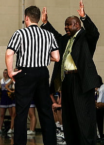 man wearing black suit standing near referee thumbnail