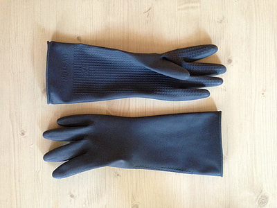 pair of gray hand gloves on top of brown wooden plank thumbnail