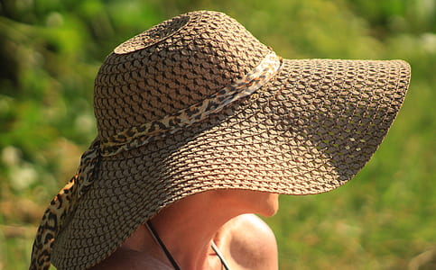 selective focus photo of person wearing taupe sunhat thumbnail
