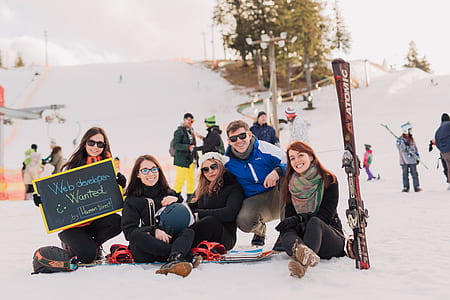 people sitting on snow during daytime thumbnail