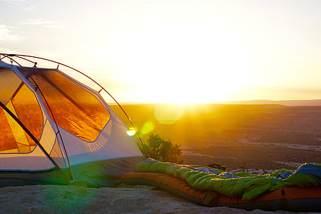 orange and white dome tent during golden hour thumbnail
