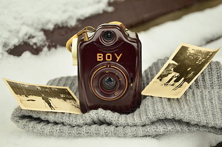 closeup photo of brown Boy camera on knit cap thumbnail