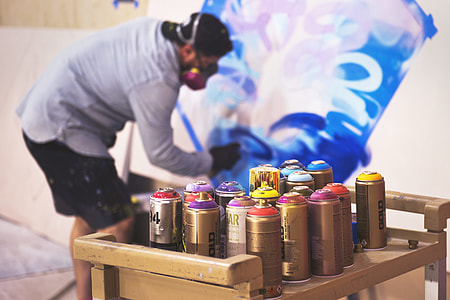paint spray bottles on table thumbnail