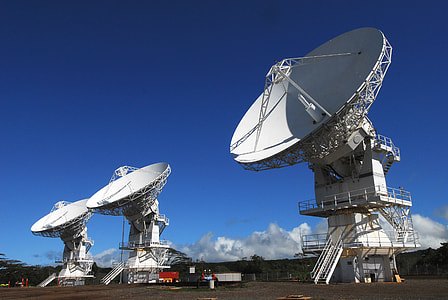 photography of white satellite receiver under blue sky during day time thumbnail