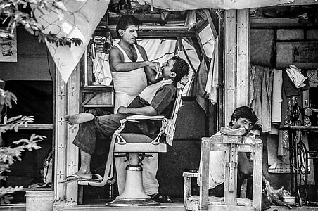 man having his haircut on a barbershop thumbnail