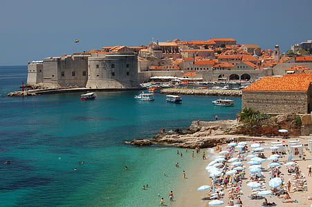 brown and orange buildings near body of water at daytime thumbnail