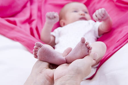 baby wearing white onesie thumbnail