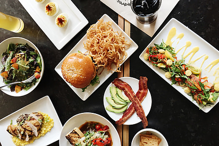 Overhead shot of plates and food at a dinner setting in a restaurant thumbnail