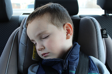 boy lying on booster seat thumbnail