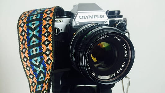 Black and Gray Olympus Dslr Camera White Orange Blue and White Strap thumbnail