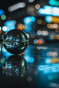 Glass Ball With Reflection of Lighted Building thumbnail