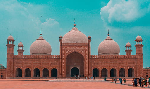 brown concrete dome building with people outside under green sky thumbnail