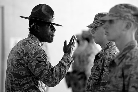 man raising hand facing officer standing in line thumbnail