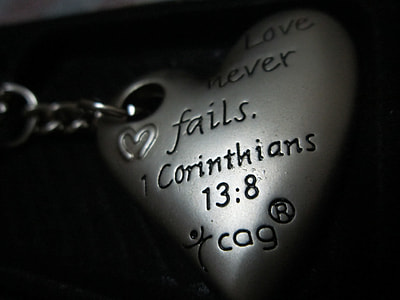 silver-colored 1 Corinthians 13:8 heart pendant thumbnail
