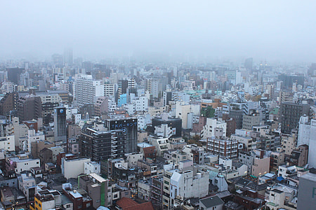 aerial photography of cityscape under cloudy sky thumbnail