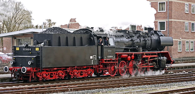 black and red steam train on brown steel railroad thumbnail